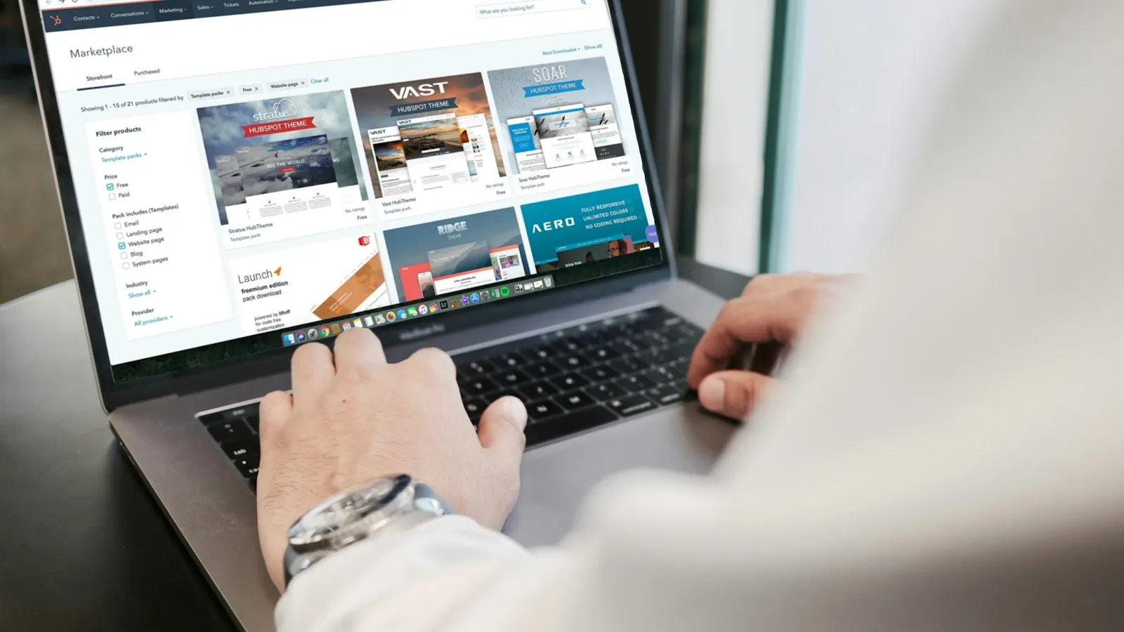 Someone working in a web dashboard on a laptop