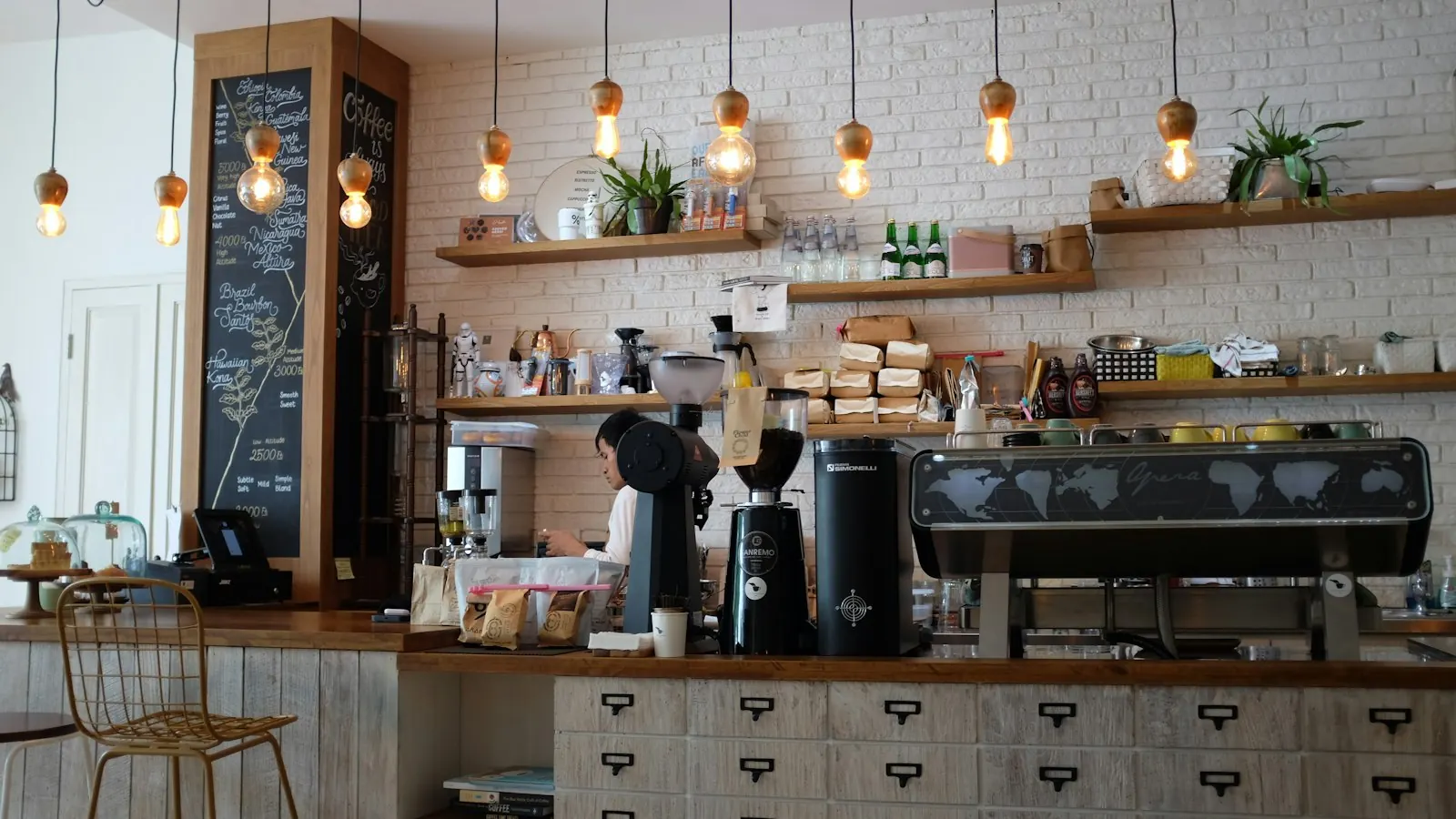Coffee shop counter with an espresso machine and a chalkboard menu